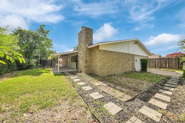 3008 Lindbergh Dr, Dallas, TX 75228 - rear view of house with a chimney, a patio area, and brick siding
