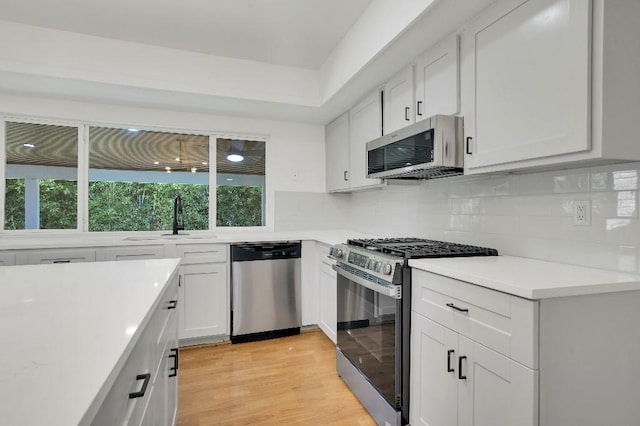 3008 Lindbergh Dr, Dallas, TX 75228 - kitchen with stainless steel appliances, plenty of natural light, backsplash, and light countertops