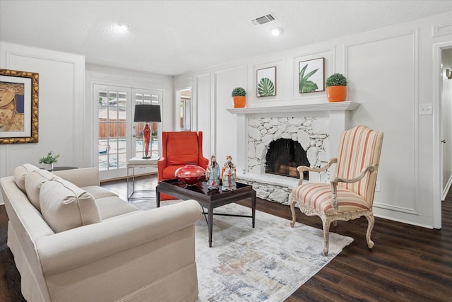 623 Harvest Glen Dr, Richardson, TX 75081 - living room featuring wood finished floors, a decorative wall, and a premium fireplace