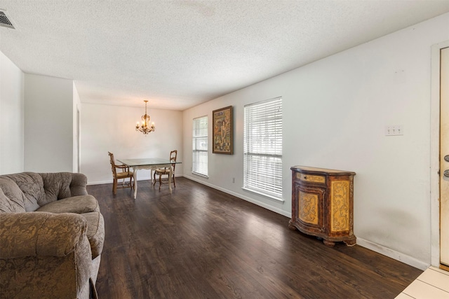 2011 Sandy Trl, Richardson, TX 75080 - living room with dark wood-style floors, a chandelier, a textured ceiling, and baseboards