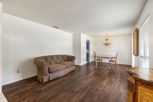 2011 Sandy Trl, Richardson, TX 75080 - living area featuring a chandelier, dark wood-style floors, a textured ceiling, and baseboards