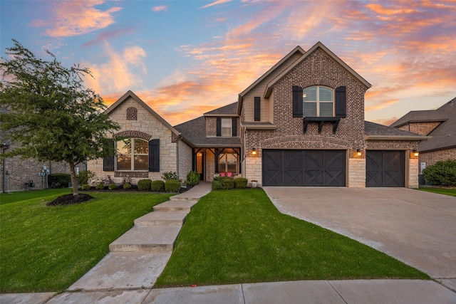 11578 Barcelona Ln, Frisco, TX 75035 - french country style house featuring stone siding, a lawn, concrete driveway, a shingled roof, and a garage