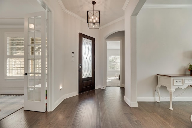 11578 Barcelona Ln, Frisco, TX 75035 - foyer featuring arched walkways, dark wood-type flooring, ornamental molding, baseboards, and french doors
