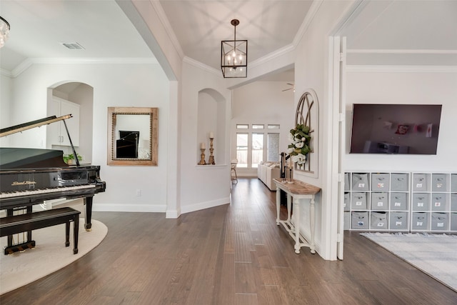 11578 Barcelona Ln, Frisco, TX 75035 - foyer entrance with dark wood-type flooring, crown molding, arched walkways, baseboards, and a chandelier