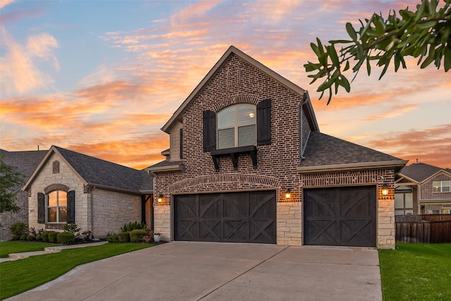 11578 Barcelona Ln, Frisco, TX 75035 - french country inspired facade with stone siding, concrete driveway, a shingled roof, brick siding, and an attached garage