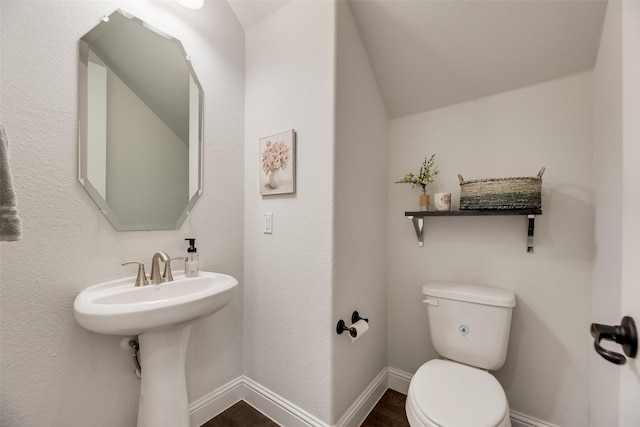 11578 Barcelona Ln, Frisco, TX 75035 - half bath featuring toilet, wood finished floors, baseboards, and vaulted ceiling