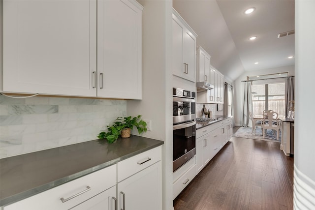 11578 Barcelona Ln, Frisco, TX 75035 - kitchen with tasteful backsplash, appliances with stainless steel finishes, white cabinetry, recessed lighting, and dark wood-type flooring