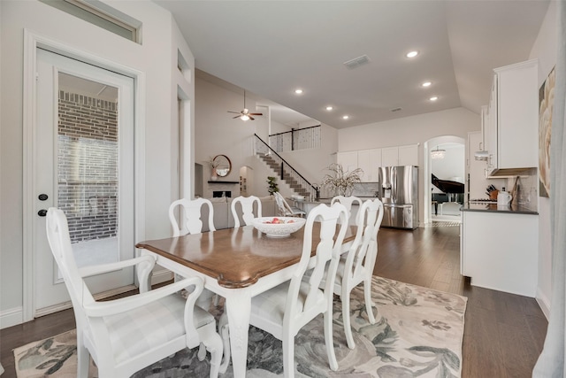 11578 Barcelona Ln, Frisco, TX 75035 - dining area featuring stairway, dark wood finished floors, arched walkways, ceiling fan, and recessed lighting