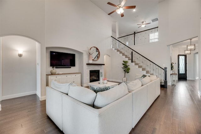 11578 Barcelona Ln, Frisco, TX 75035 - living room featuring a high ceiling, a ceiling fan, wood finished floors, a glass covered fireplace, and baseboards