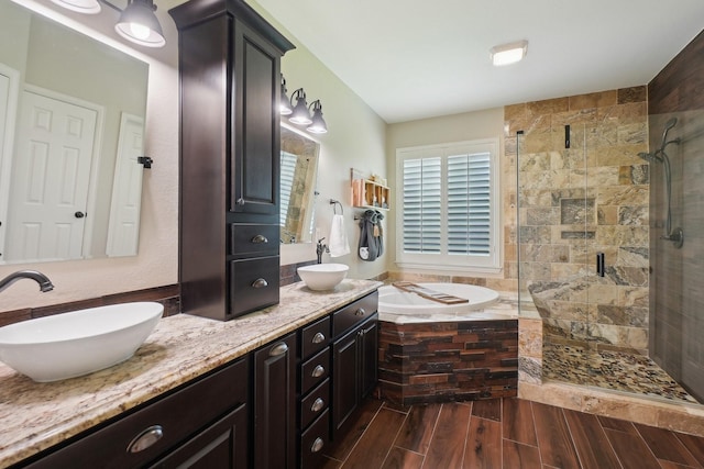 1300 Millers Creek Dr, Prosper, TX 75078 - bathroom featuring a bath, a shower stall, double vanity, and wood finished floors