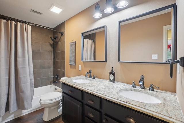 1300 Millers Creek Dr, Prosper, TX 75078 - bathroom featuring toilet, double vanity, shower / bath combination with curtain, and wood finished floors