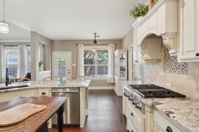 1300 Millers Creek Dr, Prosper, TX 75078 - kitchen with appliances with stainless steel finishes, a sink, light stone counters, backsplash, and decorative light fixtures