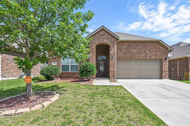 528 England St, Fate, TX 75189 - view of front of property featuring brick siding, an attached garage, driveway, and a front lawn