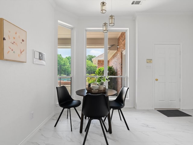 14130 Red Wood Cir S, Frisco, TX 75071 - dining space featuring light marble finish flooring, ornamental molding, and baseboards