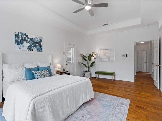 14130 Red Wood Cir S, Frisco, TX 75071 - bedroom with a tray ceiling, wood finished floors, crown molding, baseboards, and ceiling fan