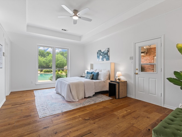 14130 Red Wood Cir S, Frisco, TX 75071 - bedroom featuring a tray ceiling, hardwood / wood-style flooring, ceiling fan, and baseboards