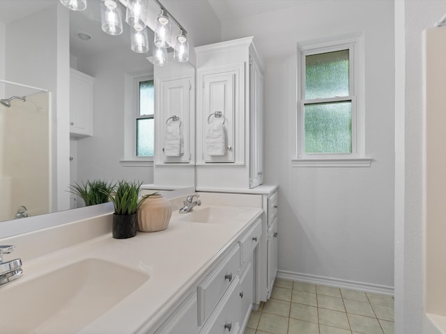 14130 Red Wood Cir S, Frisco, TX 75071 - bathroom featuring double vanity, tile patterned flooring, and baseboards