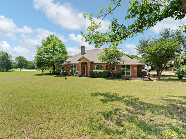 14130 Red Wood Cir S, Frisco, TX 75071 - view of front of property with a front yard, a chimney, and brick siding