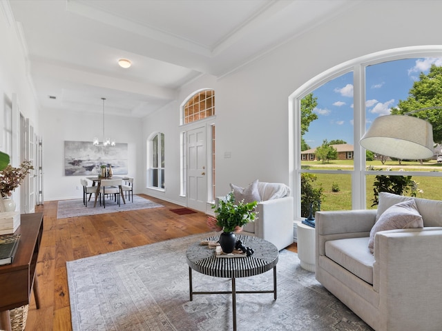 14130 Red Wood Cir S, Frisco, TX 75071 - living room featuring wood-type flooring, a chandelier, and beamed ceiling