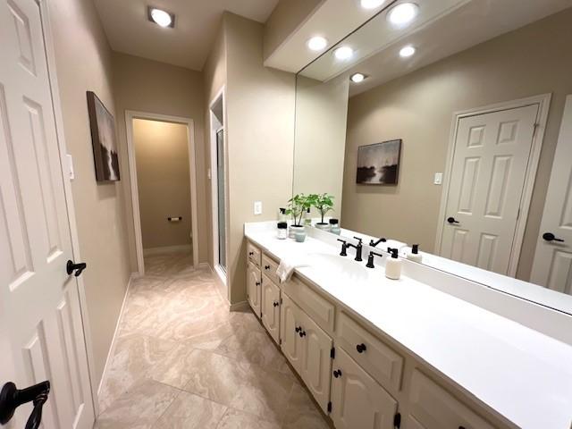 7009 Chevy Chase Ave, Dallas, TX 75225 - full bath with marble finish floors, vanity, a stall shower, baseboards, and recessed lighting