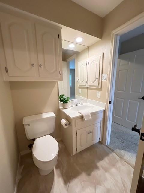 7009 Chevy Chase Ave, Dallas, TX 75225 - half bath featuring vanity, toilet, and baseboards