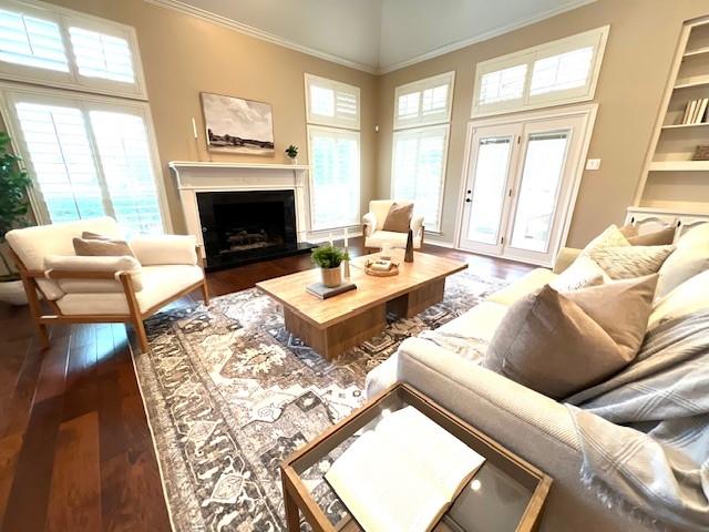 7009 Chevy Chase Ave, Dallas, TX 75225 - living area featuring hardwood / wood-style floors, crown molding, plenty of natural light, and a fireplace