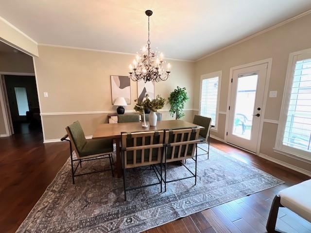 7009 Chevy Chase Ave, Dallas, TX 75225 - dining space featuring wood finished floors, healthy amount of natural light, a chandelier, baseboards, and crown molding