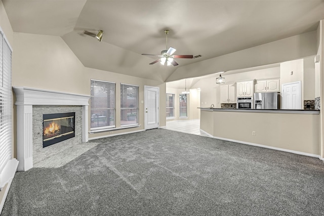 11 Enchanted Ct, Mansfield, TX 76063 - unfurnished living room featuring lofted ceiling, a ceiling fan, carpet, a fireplace, and baseboards