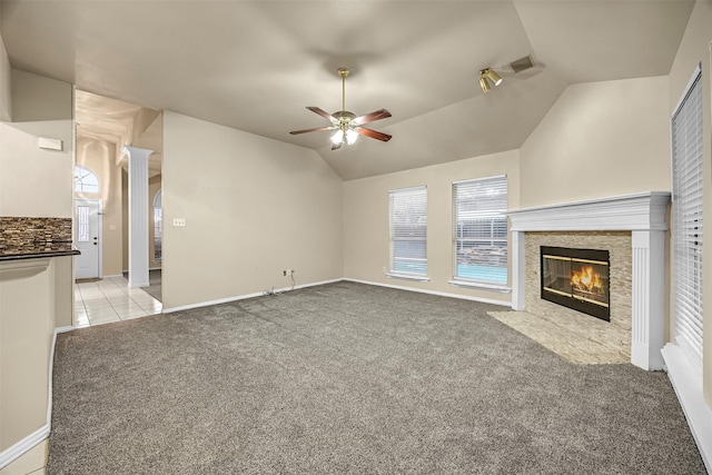 11 Enchanted Ct, Mansfield, TX 76063 - unfurnished living room featuring a ceiling fan, lofted ceiling, light colored carpet, a fireplace with flush hearth, and baseboards
