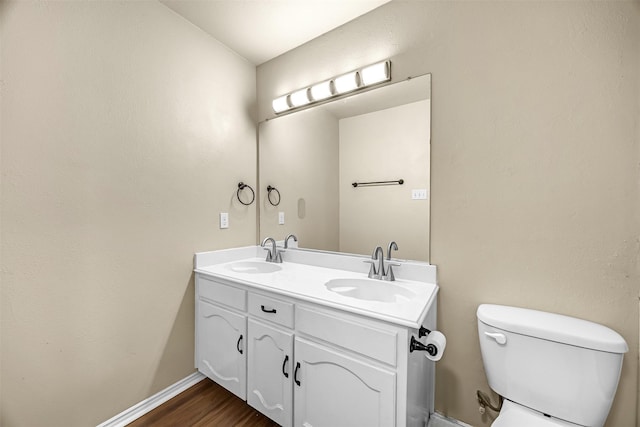 11 Enchanted Ct, Mansfield, TX 76063 - bathroom featuring toilet, double vanity, wood finished floors, and baseboards