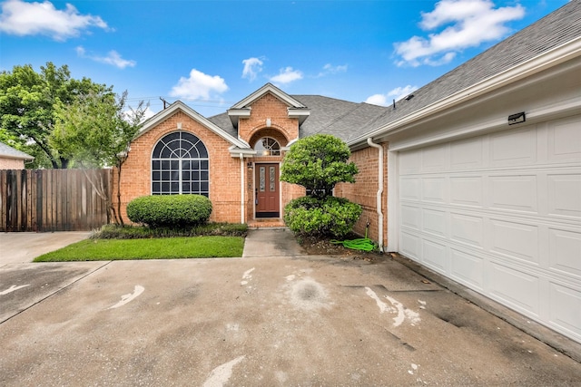 11 Enchanted Ct, Mansfield, TX 76063 - view of front of home with brick siding, roof with shingles, an attached garage, and driveway
