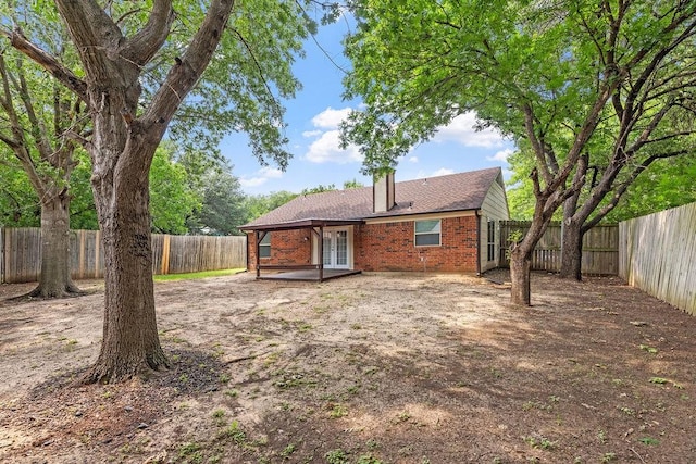 114 Juniper Dr, Arlington, TX 76018 - rear view of property featuring french doors, brick siding, a fenced backyard, and a patio