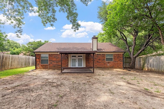 114 Juniper Dr, Arlington, TX 76018 - rear view of house featuring french doors, brick siding, and a fenced backyard