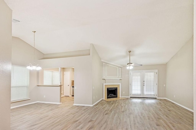 114 Juniper Dr, Arlington, TX 76018 - unfurnished living room with ceiling fan, light wood-style flooring, a chandelier, baseboards, and vaulted ceiling
