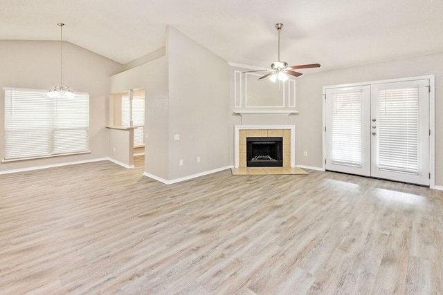 114 Juniper Dr, Arlington, TX 76018 - unfurnished living room featuring a ceiling fan, light wood-style floors, baseboards, a chandelier, and french doors