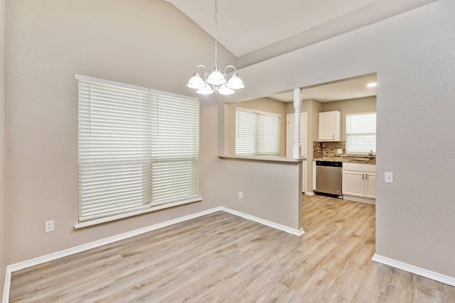 114 Juniper Dr, Arlington, TX 76018 - kitchen with dishwasher, a sink, vaulted ceiling, a chandelier, and light wood-type flooring