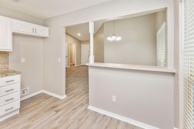 114 Juniper Dr, Arlington, TX 76018 - kitchen with baseboards, light wood-style floors, white cabinets, a chandelier, and pendant lighting