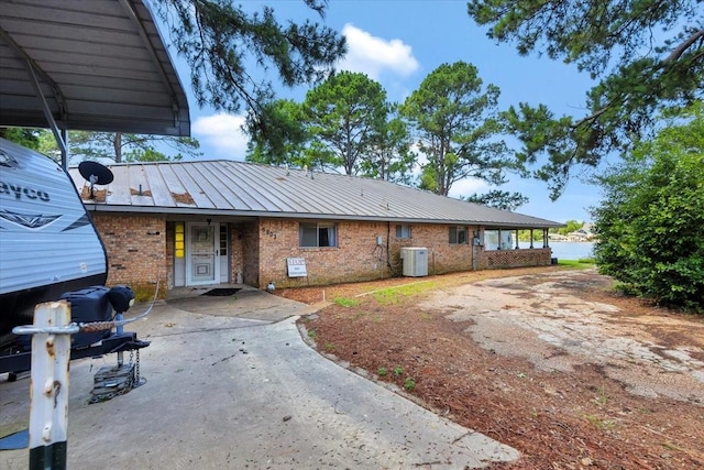6903 Scott St, Eustace, TX 75124 - view of front of house featuring concrete driveway, brick siding, cooling unit, and metal roof
