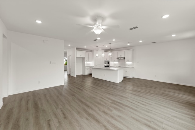 713 Roanoke, Princeton, TX 75407 - unfurnished living room with wood finished floors, ceiling fan, and recessed lighting