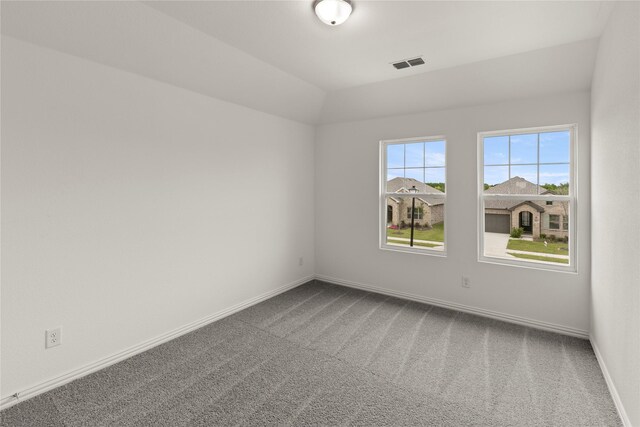 713 Roanoke, Princeton, TX 75407 - spare room featuring dark carpet and vaulted ceiling