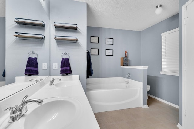 1623 Bertram Dr, Mansfield, TX 76063 - full bath featuring a garden tub, double vanity, baseboards, a textured ceiling, and toilet