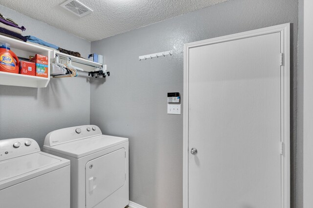 1623 Bertram Dr, Mansfield, TX 76063 - laundry area with washing machine and clothes dryer and a textured ceiling