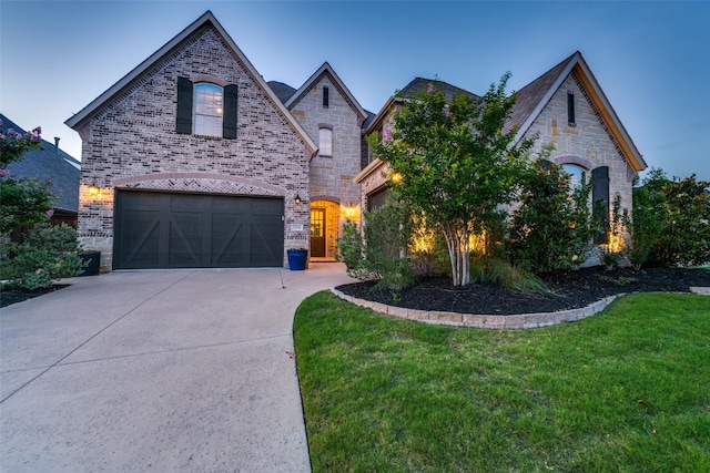 15186 Crape Myrtle Rd, Frisco, TX 75035 - french provincial home featuring a garage, a front yard, concrete driveway, brick siding, and stone siding