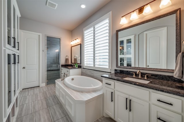 15186 Crape Myrtle Rd, Frisco, TX 75035 - bathroom with a shower stall, a bath, and two vanities