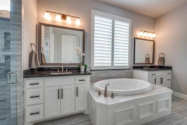 15186 Crape Myrtle Rd, Frisco, TX 75035 - bathroom with two vanities, a stall shower, and a garden tub