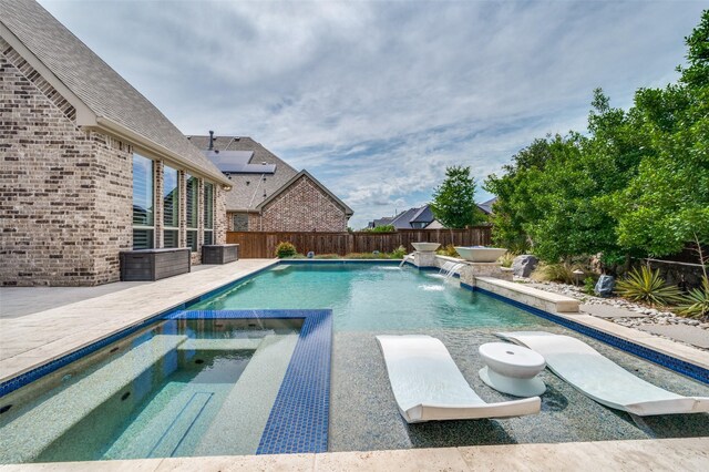 15186 Crape Myrtle Rd, Frisco, TX 75035 - view of swimming pool featuring a pool with connected hot tub, a fenced backyard, and a patio area