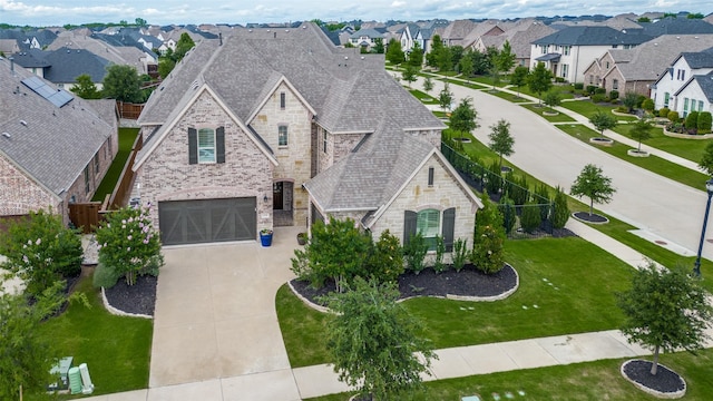 15186 Crape Myrtle Rd, Frisco, TX 75035 - french country inspired facade with stone siding, concrete driveway, a residential view, and roof with shingles