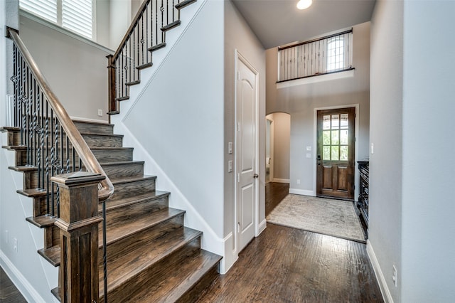 15186 Crape Myrtle Rd, Frisco, TX 75035 - entryway with wood finished floors, arched walkways, stairway, baseboards, and a towering ceiling