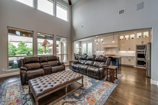 15186 Crape Myrtle Rd, Frisco, TX 75035 - living area featuring dark wood-style floors, a high ceiling, and baseboards
