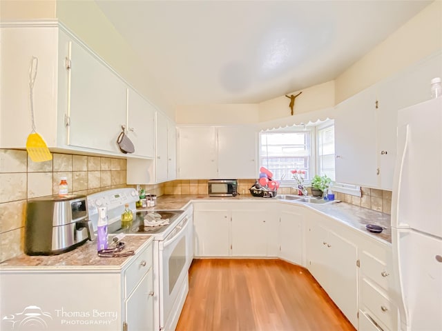 3816 State St, Abilene, TX 79603 - kitchen featuring white appliances, light wood-type flooring, white cabinetry, and backsplash